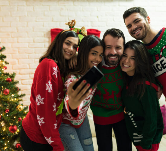 Friends Making Memories While Enjoying Christmas At Home